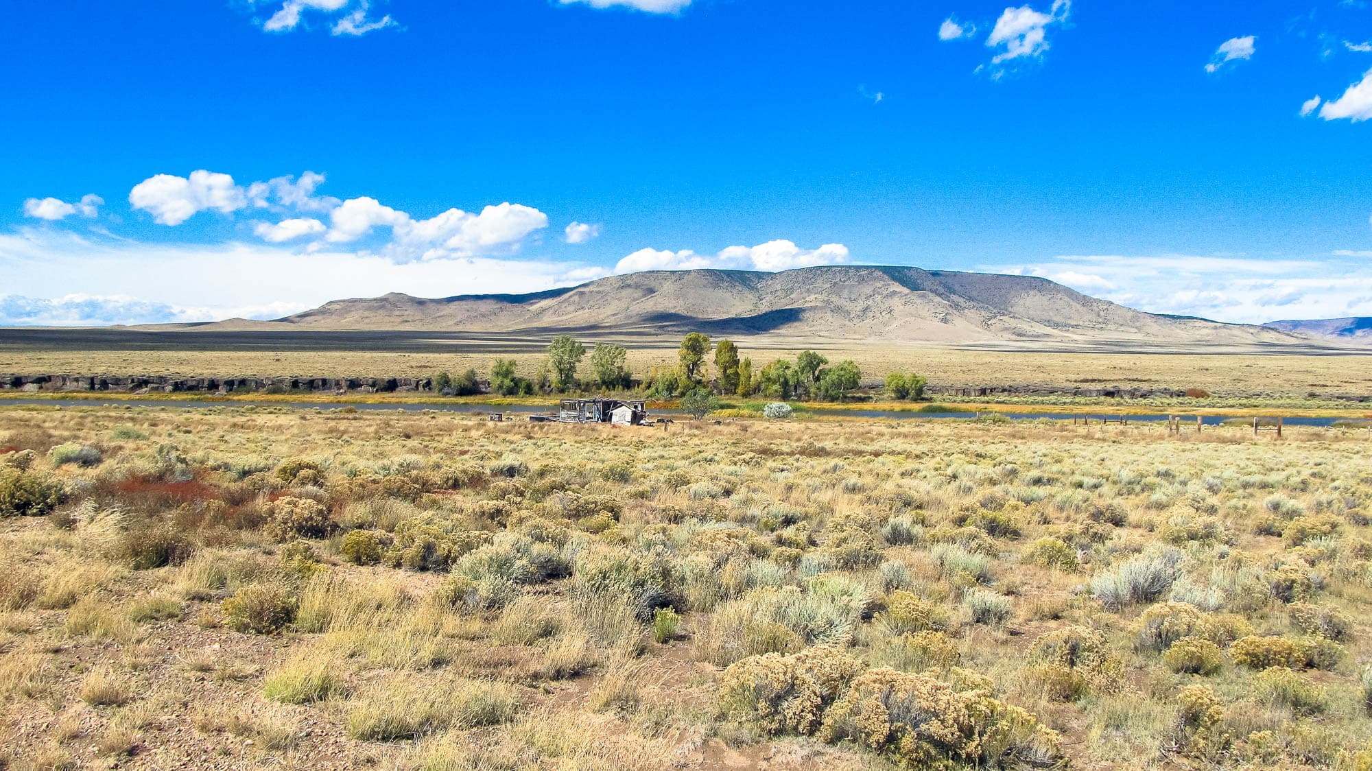 Ground view looking west toward an old shed structure on the property in Costilla County, Colorado.
